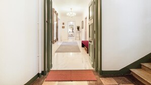 A hallway with a marble floor, a red carpet, and a staircase on the right. - 3 Bedroom Apartment in Heart of Cannes (Cannes)