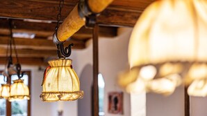 Hanging lamps with a ruffled design, wooden beams, and a window in the background. - Knödelhof 'Room A', Twin Room – Guesthouse near Munich (Putzbrunn)