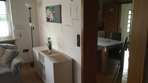 A compact living space with a kitchenette, a dining area, and a small seating area. - Apartment 'Fewo Eberau' with Shared Garden and Wi-Fi (Ebrach)