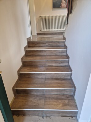 A staircase with wooden steps leading to a landing.