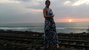 A person standing on railway tracks with a sunset in the background. - Stay next to the sea but central to all your need.  (Colombo)