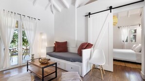 A modern, minimalist room with a built-in bench, a small table, and a chair. - Peaceful Villa at Apanema Mindfulness Lefkada (Sfakiotes)