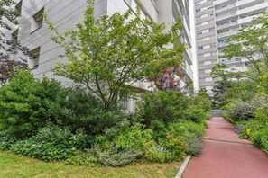 Residents enjoy a peaceful retreat in a beautifully maintained garden with a walkway.