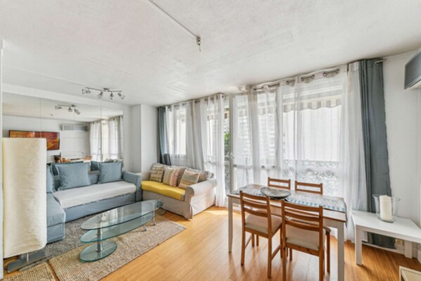 Relax in this open-plan living space with a central seating area and dining table.