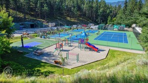 A playground with multiple play areas, including a basketball court and a slide. - 3 BDRM / Lake Access / Year round Indoor pool (Windermere)