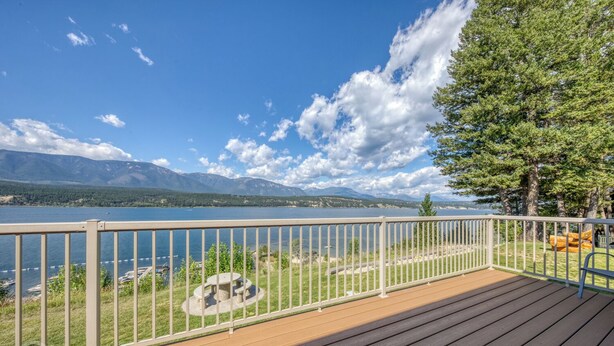 A deck with a view of a lake and mountains. - 3 BDRM / Lake Access / Year round Indoor pool (Windermere)