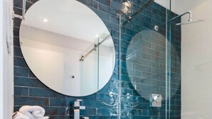 A modern bathroom with a glass-enclosed shower, a white sink, and a mirror above it. - w* | Perfect 2BR in Casco Antiguo w/ Balcony (Panamá)