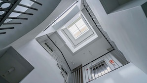 A modern interior with a central skylight, a staircase, and a fire alarm. - w* | Airy 1BR w/ Balcony in Panama (Panamá)