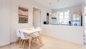 A modern kitchen with white cabinets, a stainless steel refrigerator, and a built-in oven. - w* | Vivid 1BR w/ Magical lighting in Panama (Panamá)