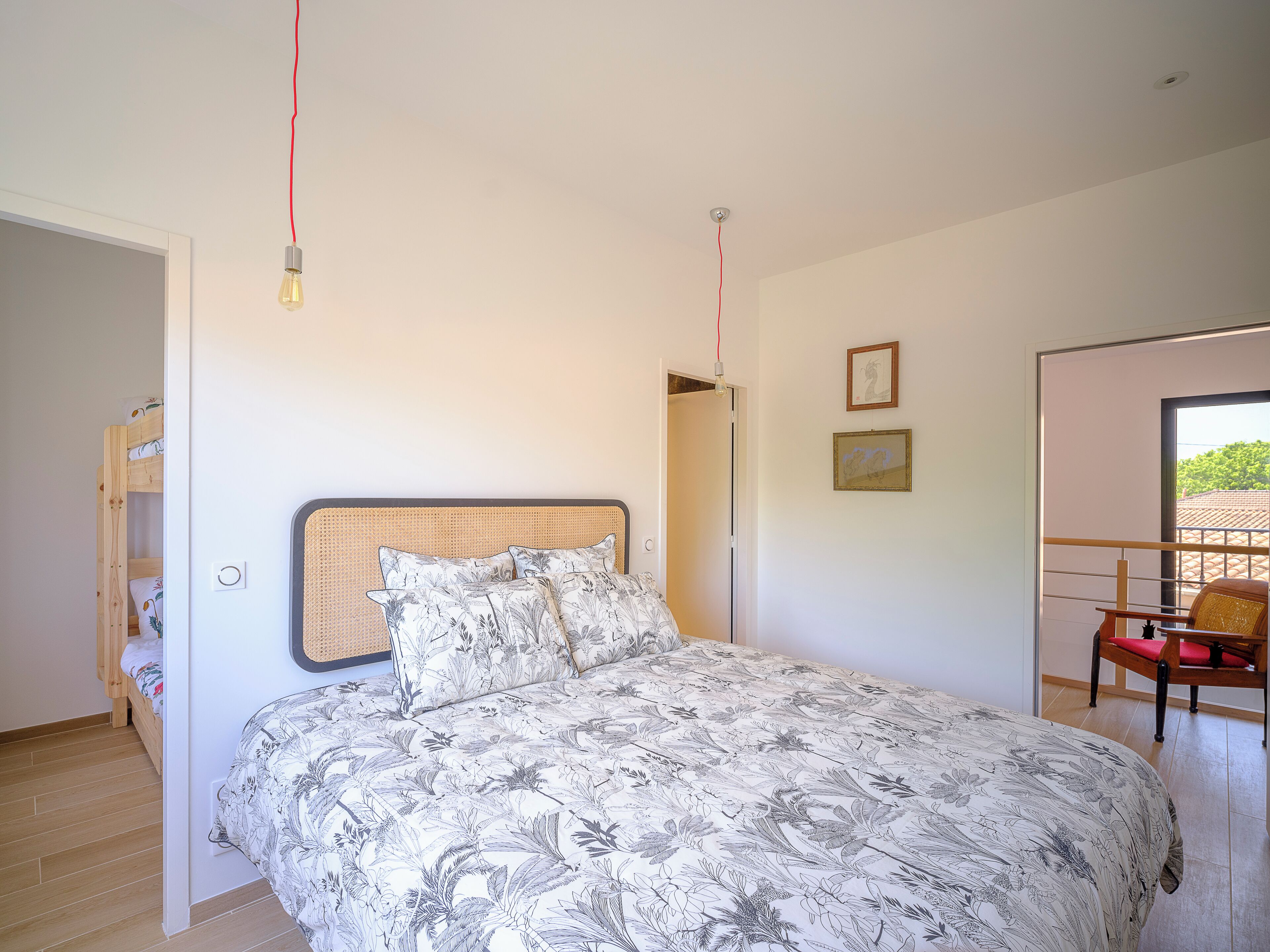 Ein Schlafzimmer mit Bett, Stuhl, Tür und Fenster.