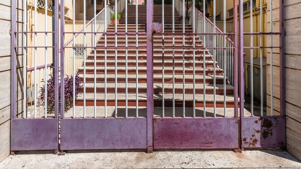 A gated entrance with a staircase leading to a building. - Magi Apartment in Rome (Rome)