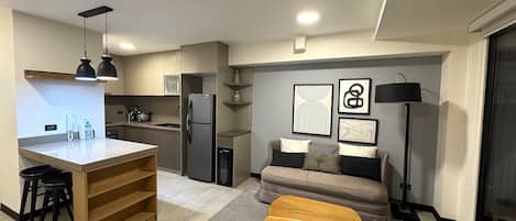 Business Apartment, 1 Bedroom, Housekeeping, Executive Level | Living area | 55-inch Smart TV with digital channels