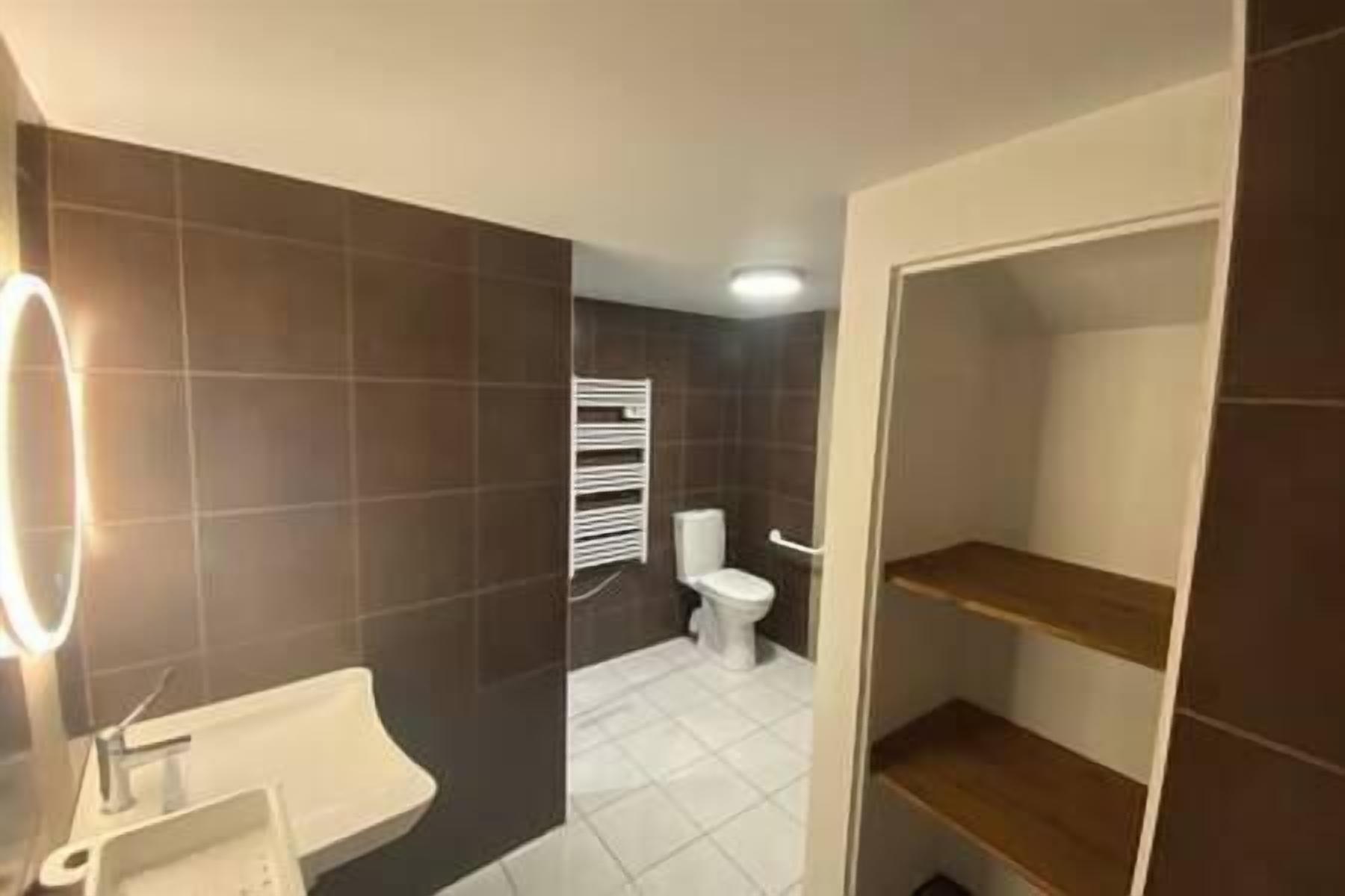 Ein Badezimmer mit Waschbecken, Toilette und Duschbereich.