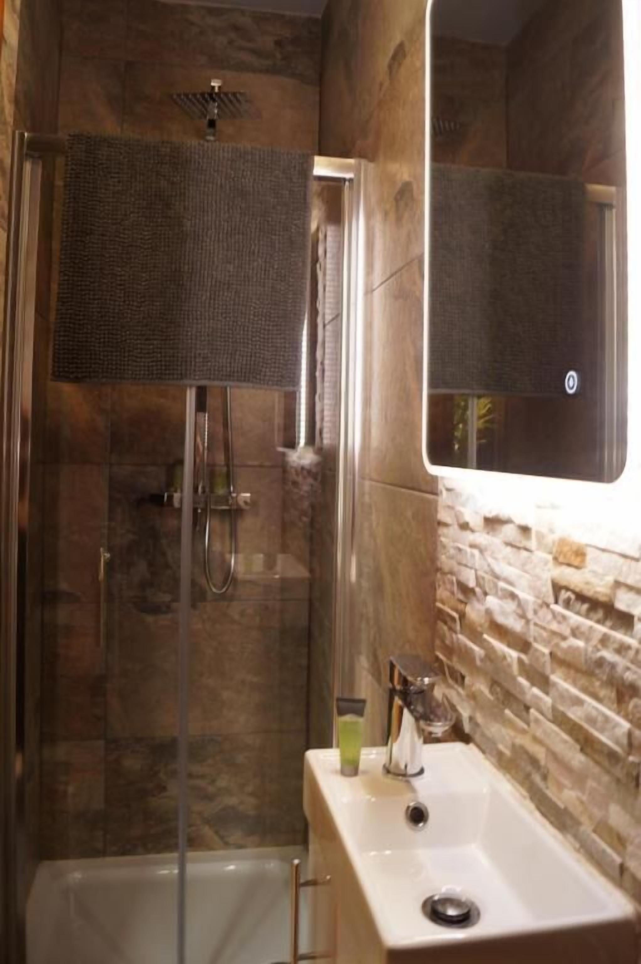 Shower, rainfall showerhead, towels, soap