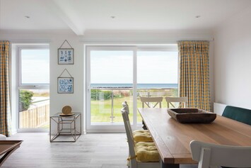 Dining table seating area overlooking the garden and sea view 