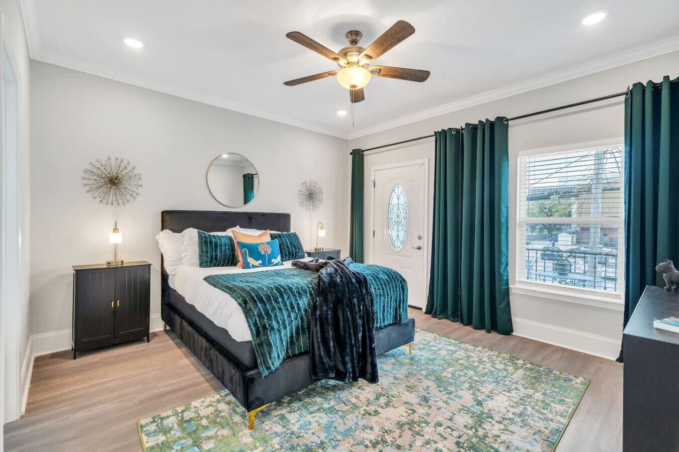 Primary suite with queen bed and door to private balcony