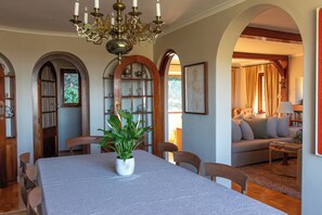 Relax in this elegantly furnished living area with a dining table for four, comfortable sofa, and a cozy seating area.