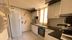 A compact kitchen with white cabinets, a built-in oven, and a microwave. - Studio Loft 4 people, Pool, Port Barcarès (Le Barcarès)