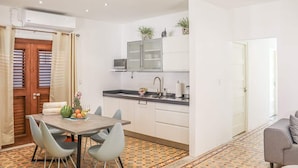Una cocina compacta con zona de comedor, microondas y refrigerador.