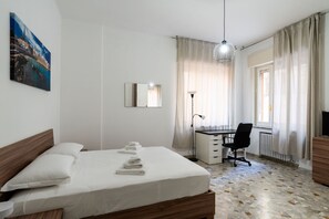 A bedroom with a bed, a desk, a chair, and a radiator. - Casa Matt a Mare by Wonderful Italy (Bari)