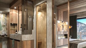 A modern bathroom with a wooden vanity, a glass shower enclosure, and a large mirror.