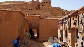 Traditional village architecture with earthen buildings and narrow pathways.
