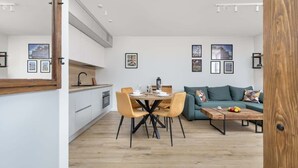 A modern living space with a dining area, a sofa, and a coffee table.
