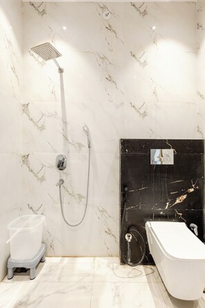 A bathroom with a shower, a toilet, and a sink. - Lime Tree B&B Pari Chowk (Greater Noida)