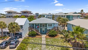 A residential area with houses, a visible street, and parked cars. - Bahama West by Panhandle Getaways (Panama City Beach)