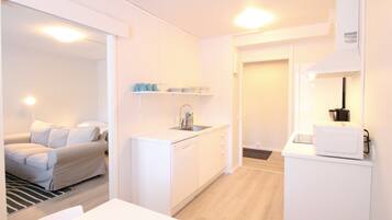 Standard Apartment | Living area | 32-inch TV with cable channels