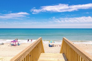 A wooden boardwalk leading to a beach with a clear sky. - Shore N' Tell - Luxury 5BR Home - Cov. Porch, Elevator, Gazebo and More! (Surf City)
