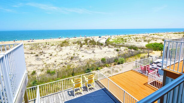 A deck with a view of a beach and ocean. - Sea Edge 3-Oceanfront 36th St, W/D, AC, Free WIFI (Ocean City)