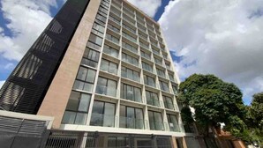 A modern high-rise building with a grid of windows and a flat roof. - Buena Vista Rental House (Santa Cruz)
