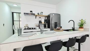 Fridge, microwave, coffee/tea maker, cookware/dishes/utensils