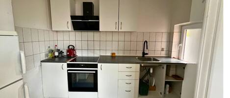 Fridge, stovetop, dishwasher, coffee/tea maker