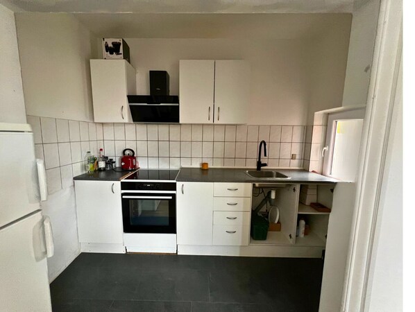 Fridge, stovetop, dishwasher, coffee/tea maker