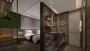 A modern hotel room with a bed, bedside table, and a small seating area. - Zhouchun Hotel (Zibo)
