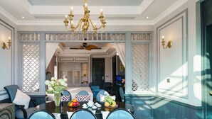 A dining area with a chandelier, a ceiling fan, and a view into the dining room.