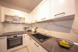Apartment, 2 Bedrooms, Balcony | Private kitchen | Toaster, paper towels, dining tables