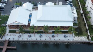 A waterfront restaurant with a white roof and multiple dining areas. - Tropical Waterfront Pool Home, Private Dock, Kayaks, Direct Access to Tampa Bay! (Apollo Beach)