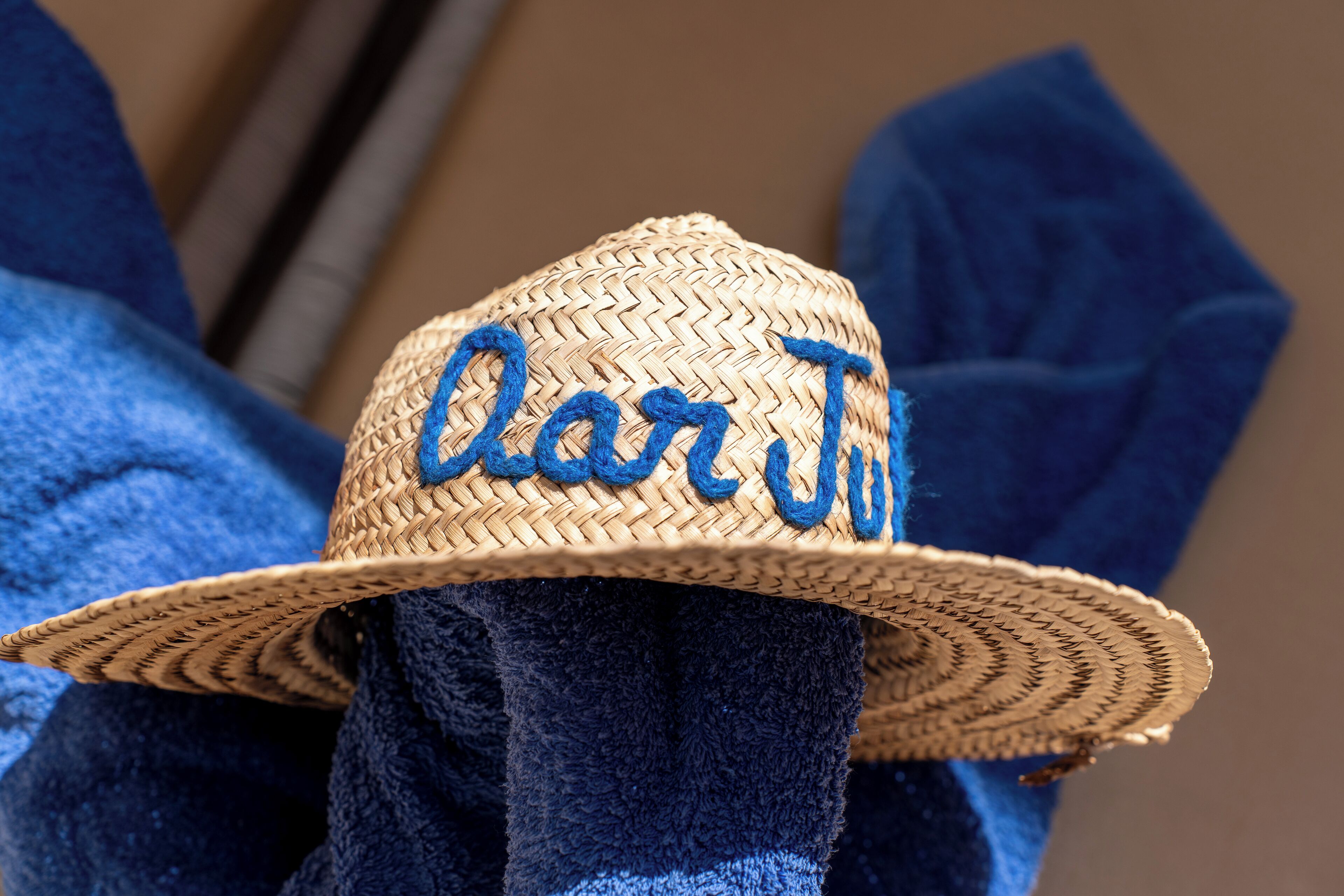 A straw hat with the word "Caribbean" embroidered on it.