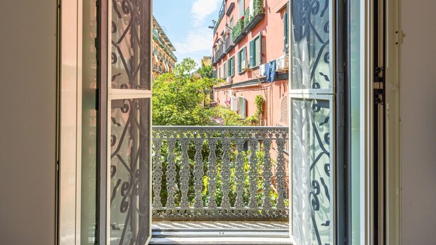 An open balcony with ornate metal railings, a view of adjacent buildings, and a clear sky. - Smooth Vibes at Chiaia by Napoliapartments (Naples)