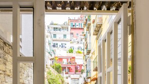 A narrow street with buildings on both sides, a staircase, and a door leading to a balcony. - Smooth Vibes at Chiaia by Napoliapartments (Naples)