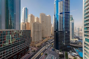 A high-rise building with multiple floors, surrounded by other tall buildings.