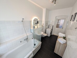 Een haardroger, handdoeken, zeep, toiletpapier
