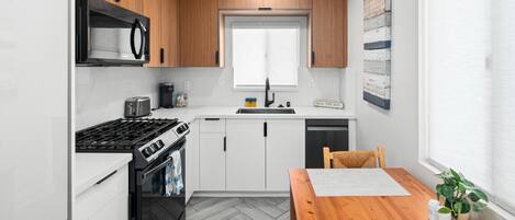 Fridge, coffee/tea maker, highchair, cookware/dishes/utensils