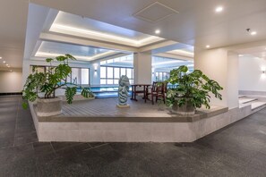 A modern indoor space with a pool, seating area, and potted plants. - Level 25 1 Bed with Marble Lined Bath City Views (Auckland)