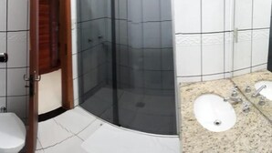 A bathroom with a shower enclosure, two sinks, and a toilet. - Bravo City Hotel Primavera do Leste (Primavera do Leste)