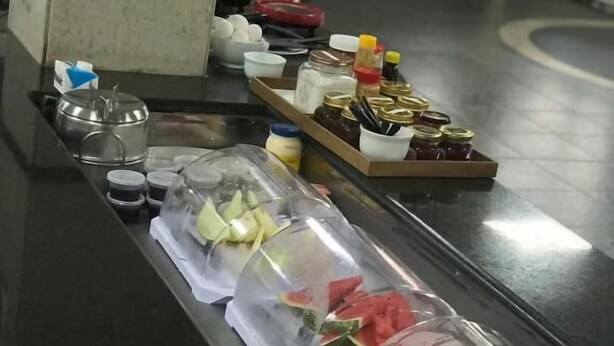 A buffet line with various food items in covered containers. - Bravo City Hotel Primavera do Leste (Primavera do Leste)