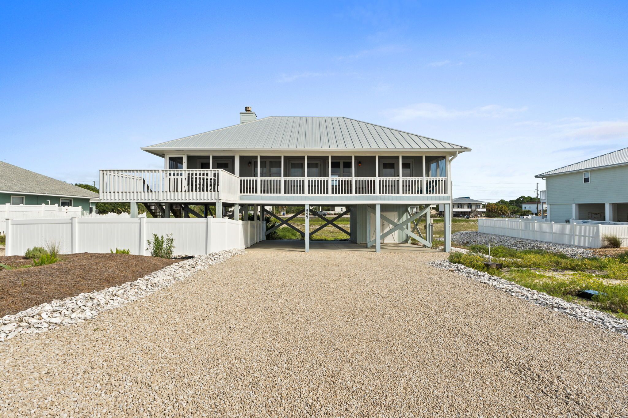 A two-story building with a flat roof and a balcony on the upper floor.